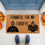 Personalized Thanksgiving doormat featuring two turkey illustrations and the text Thankful For My Turkeys, this natural coir welcome mat is a festive fall porch decor piece for your home entrance with pumpkins and autumn leaves.