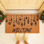 Christmas welcome doormat featuring hanging ornaments and light bulb designs on natural coir fiber, perfect for a festive front porch entry mat.