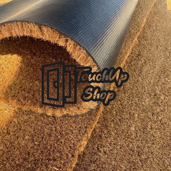 a close-up view of a black and brown doormat with the text "TouchUp Shop" overlaid on it.
