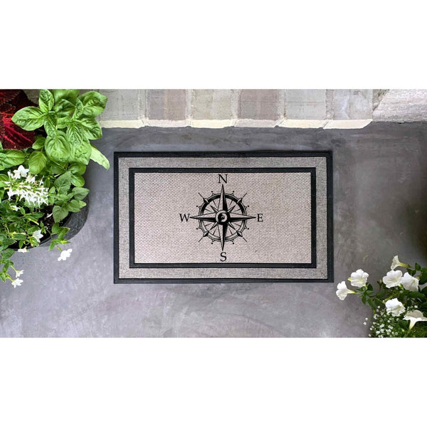 Compass rose doormat featuring a nautical design on a textured gray surface, this outdoor welcome mat serves as a stylish front porch rug for your home entrance, providing a durable floor covering for your entryway or patio decor.