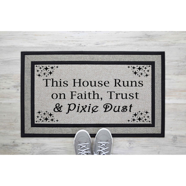 Faith Trust and Pixie Dust doormat featuring a whimsical quote on a gray textured surface, perfect as a front porch welcome mat or entryway rug for fans of magical home decor and fantasy themed housewarming gifts for new