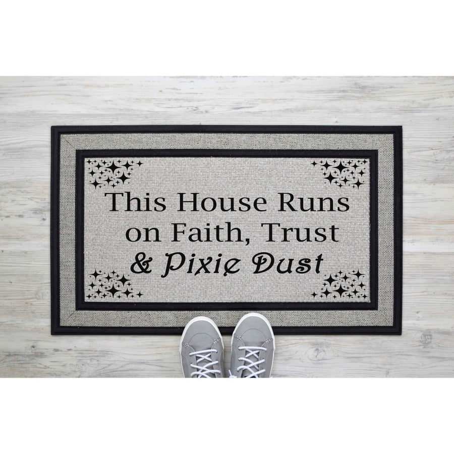 Faith Trust and Pixie Dust doormat featuring a whimsical quote on a gray textured surface, perfect as a front porch welcome mat or entryway rug for fans of magical home decor and fantasy themed housewarming gifts for new