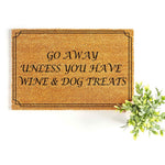 Funny Go Away Unless You Have Wine and Dog Treats doormat made of natural coir fiber, featuring a black border and bold text for a humorous front porch welcome mat that is perfect for any dog lover or wine enthusiast home decor.