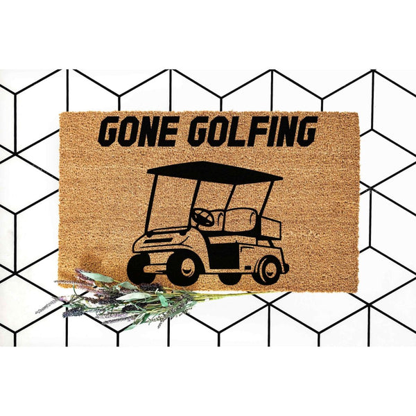 Gone Golfing coir doormat featuring a black golf cart graphic on natural fiber, this funny outdoor welcome mat is a great front porch decor piece for golf lovers and makes a unique housewarming entry rug for any home or golf