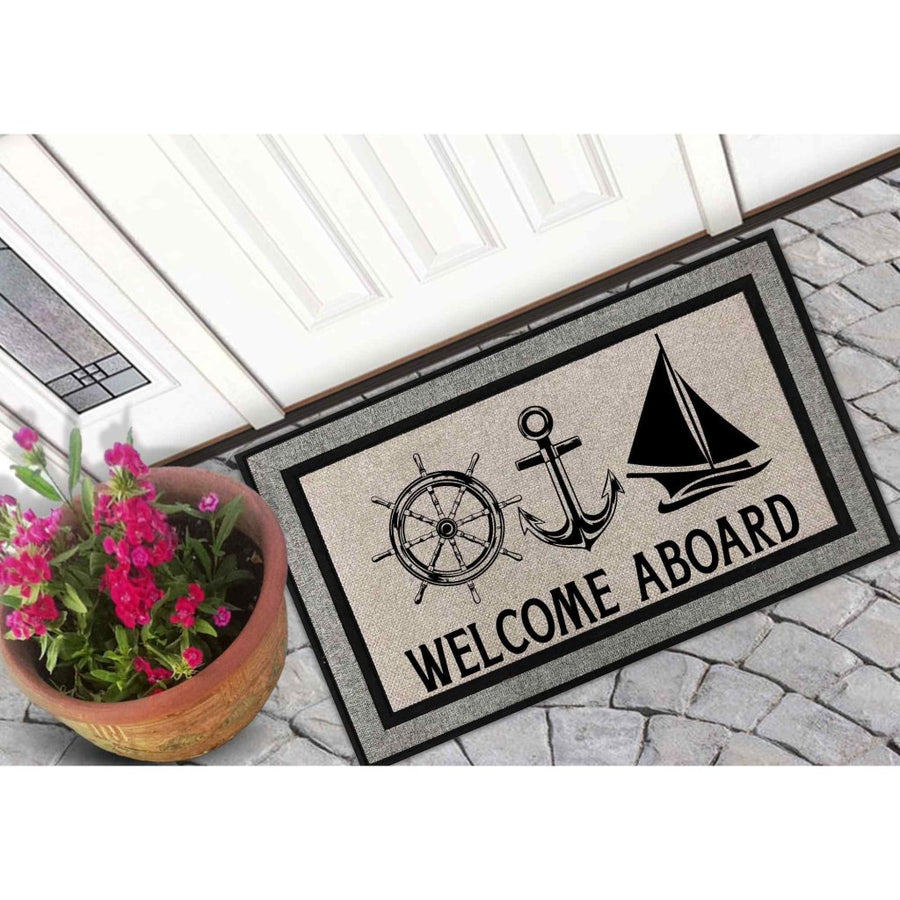 Nautical Welcome Aboard doormat featuring a ship wheel, anchor, and sailboat design on a gray textured mat, placed on a stone porch by a white door with a potted plant, perfect for coastal home decor and outdoor entryway floor