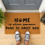 a welcome mat that says home is where someone runs to greet you