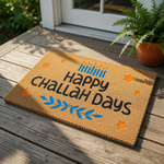 A mat with the text "Happy Challah Days" printed on it, surrounded by orange stars and blue leaves.