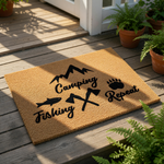 A carpet with the text "Camping Fishing Repeat" printed on it, along with various camping-related icons such as a fish, a bear paw, and camping tools.
