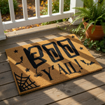 A door mat with the text "BOO Y'ALL!" printed on it, along with bats and a spider web design.