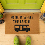 a door mat that says home is where you park it