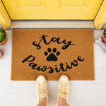 a door mat that says stay positive with a dog's paw