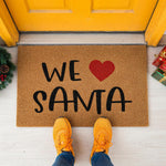 a welcome mat with the words we love santa written on it