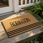 A beige doormat with the name "ROBINSON" printed on it in bold black letters.