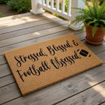 A textured doormat with the text "Stressed, Blessed & Football Obsessed" printed on it.