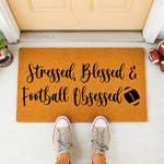 a door mat that says, stressed, blessed, football messed