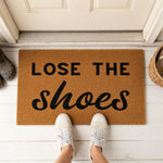 a door mat that says, lose the shoes