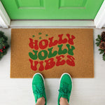 a door mat with the words holly jolly vibes on it