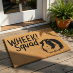 A door mat with a cartoon image of a guinea pig and the text "WHEek!