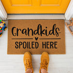 a door mat that says grandkids spoiled here
