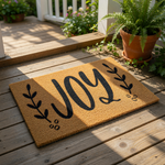 a christmas door mat with the word joy on it