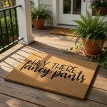 A textured area rug with the phrase "HEY THERE FANCY PANS" printed on it.