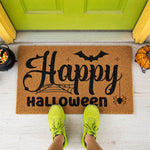 a happy halloween door mat with bats on it