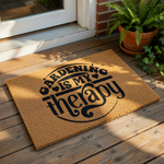 A door mat with the text "GARDENING IS MY THERAPY" printed on it.