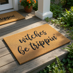 A textured area rug with the phrase "witches be trickin'" printed on it.