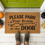 a door mat that says please park your broom at the door