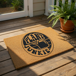 A door mat with the text "PLANT JUNKIE" printed on it.