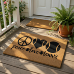 A door mat with the text "Peace love tennis" printed on it, featuring a peace sign, a heart, and a tennis ball.