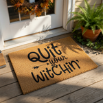 A textured area rug with the phrase "Quit your Witchin'" printed on it.