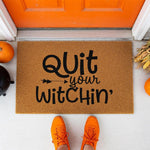 a door mat that says quit your witch