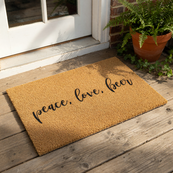 A textured doormat with the phrase "Peace. love. beer" printed on it.