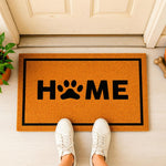 a door mat that says home with a dog's paw on it