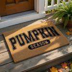 A textured door mat with the word "PUMPKIN" printed on it, along with the word "SEASON" below it.