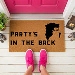 a person standing in front of a door mat that says party's in the
