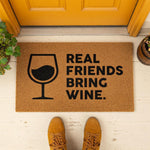 a door mat that says, real friends bring wine