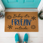 a door mat that says baby it's frozen outside