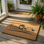 A textured doormat with the text "Home is where the heart is" printed on it.