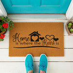 a door mat that says home is where the heart is