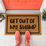 a door mat that says get out of my swamp