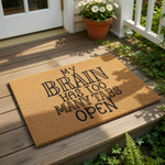 a humorous text that reads "My brain has too many tabs open", accompanied by a small potted plant on a textured surface.