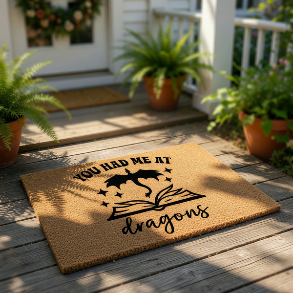 A wooden door mat with a dragon and the text "YOU HAD ME AT DRAGONS" printed on it.