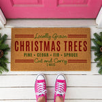 a door mat that says, locally grown christmas trees pine, cedar, fir,