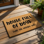 A textured doormat with the phrase "house full of boys [hope you brought wine]" printed on it.