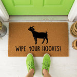 a door mat with a goat saying wipe your hooves