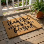 A textured area rug with the phrase "Thankful & Blessed" printed on it.