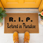 a door mat that says rip retired in paradise