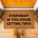 a door mat that says everybody in this house getting tipsy